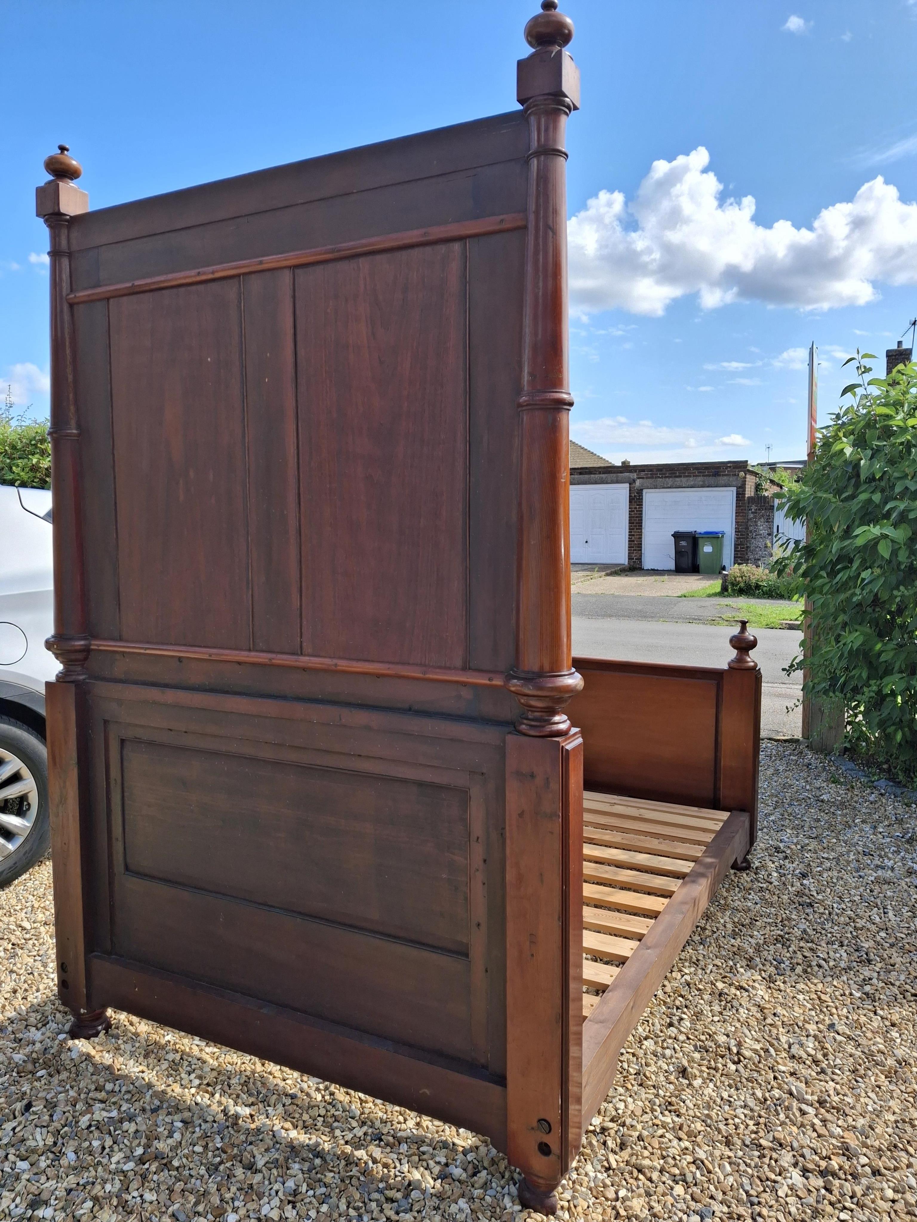A Victorian mahogany bed frame, width 151cm, height 242cm accompanied by cream jacquard bed cover, cushions and bolsters